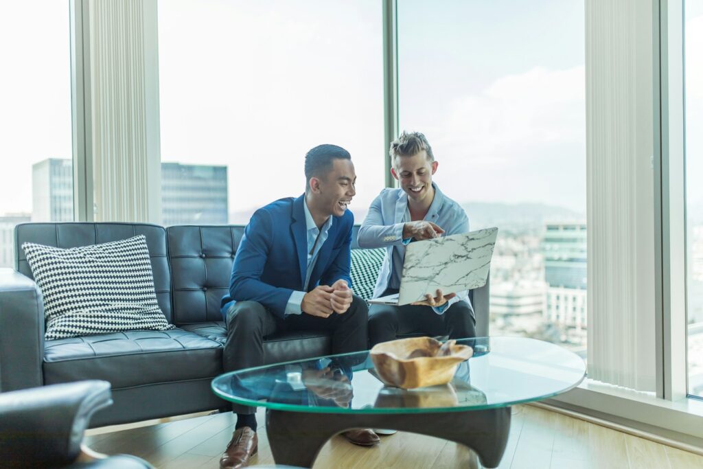 two business partners in suit sitting on sofa