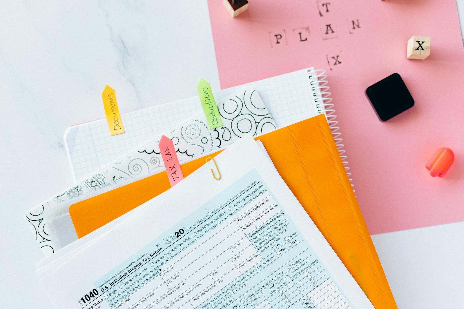 Overhead view of tax documents, forms, and organized work area for tax preparation.